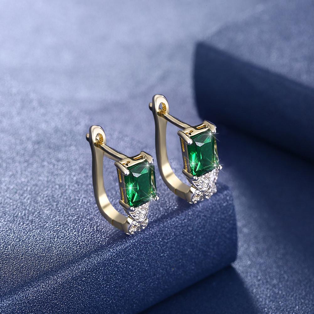 Elegant Green Emerald Cut Twisted Earrings featuring certified crystals and 18K gold plating, showcasing a unique twisted design.