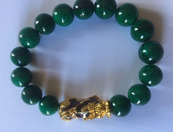 A beautifully handcrafted Green Jade Pixiu Bracelet featuring 10 mm jade beads on a stretch cord, symbolizing prosperity and financial growth.