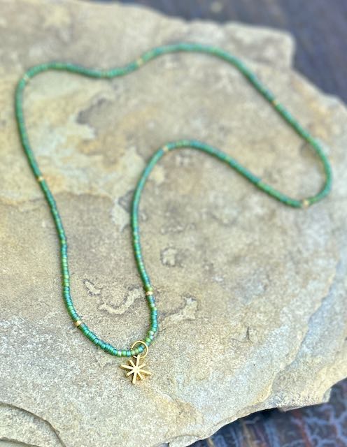 A beautiful Green Rainbow & Gold or Silver Starburst Bling Stretchy Seed Bead necklace featuring Czech glass seed beads and a metallic starburst charm.