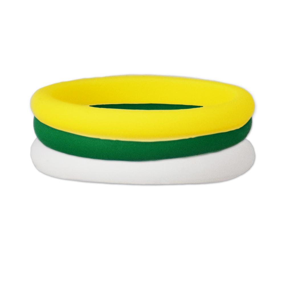 A set of green, yellow, and white stackable silicone rings displayed together, showcasing their vibrant colors and flexible design.