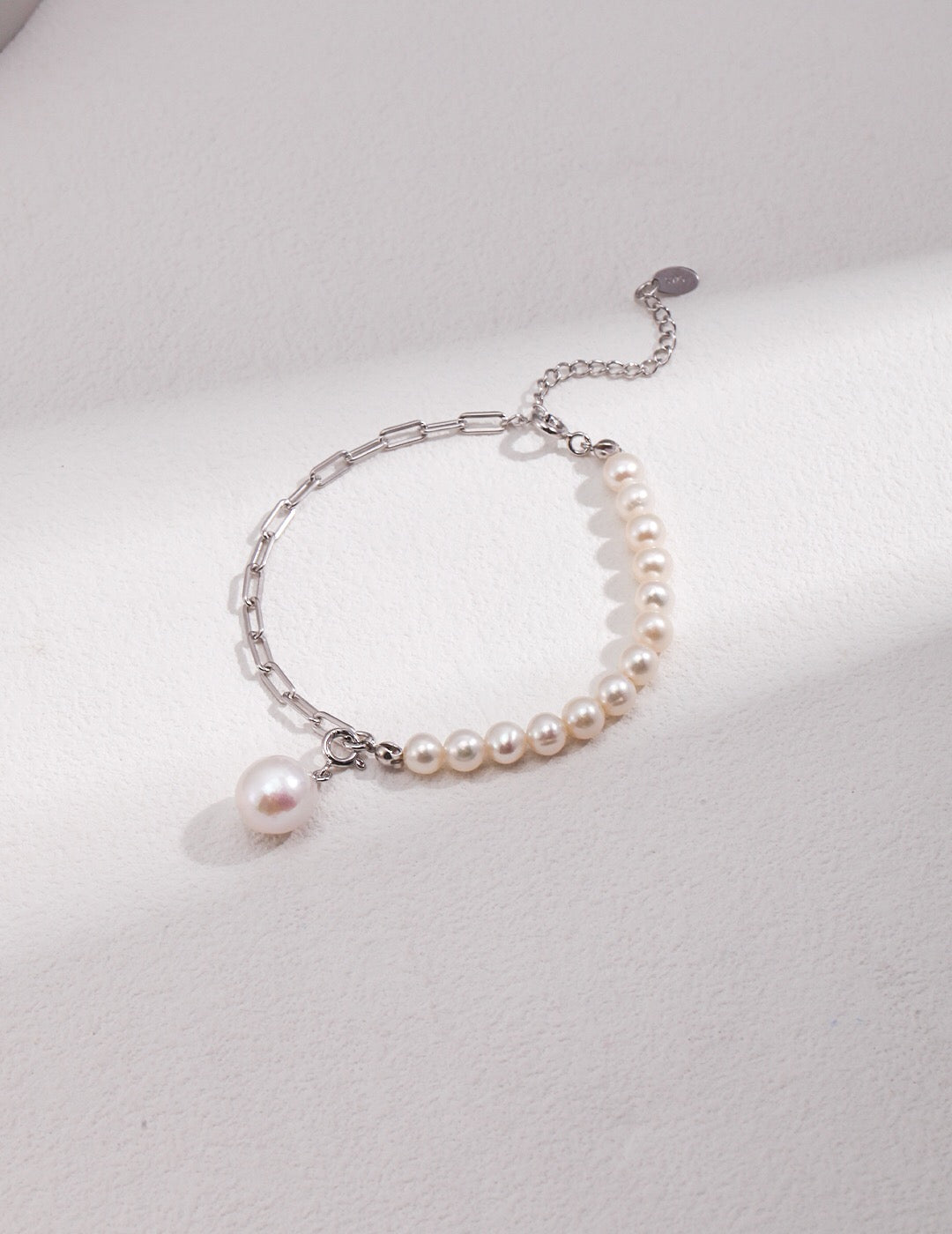 Half Chain Half Pearl Pendant Bracelet featuring natural pearls and sterling silver, elegantly designed for a sophisticated look.