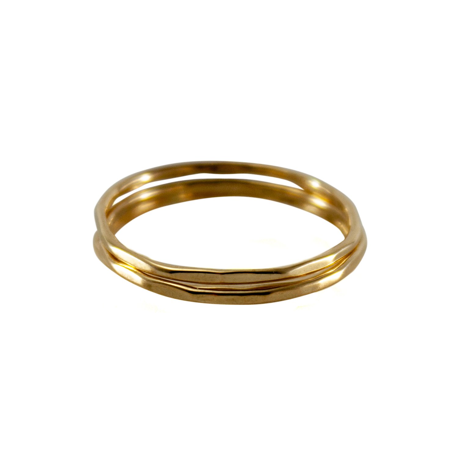 A stylish stack of three slim hammered rings made from 14k gold filled material, showcasing a minimalist design perfect for everyday wear.