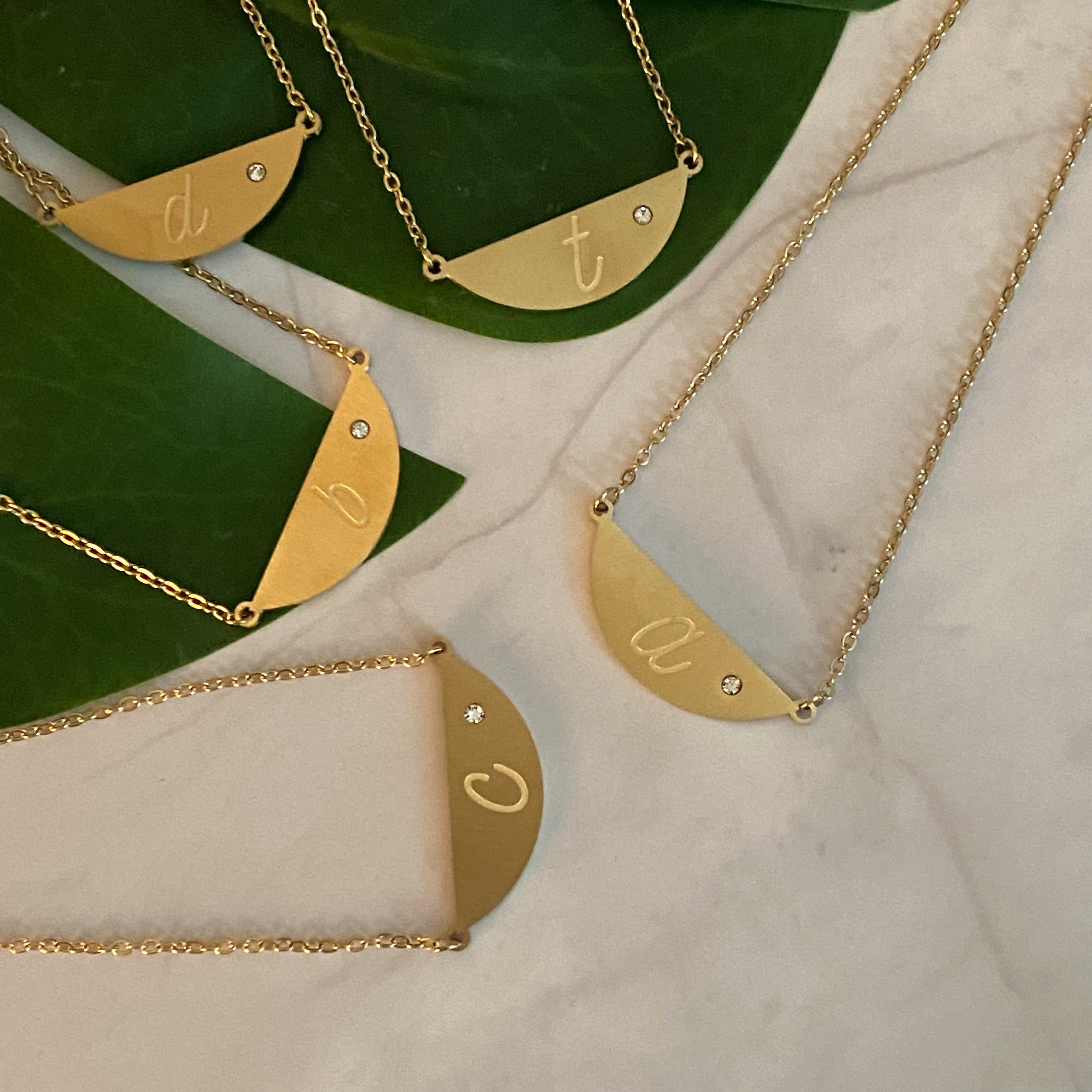 Hamilton Sphere Initial Necklace featuring a modern pendant design with an engraved initial and a brushed finish.