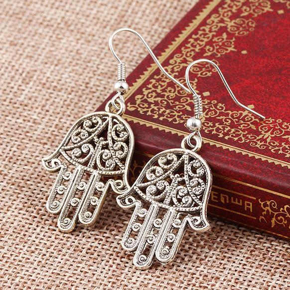 Elegant Hamsa Drop Earrings in 18K white gold plating, showcasing intricate design and luxurious finish.