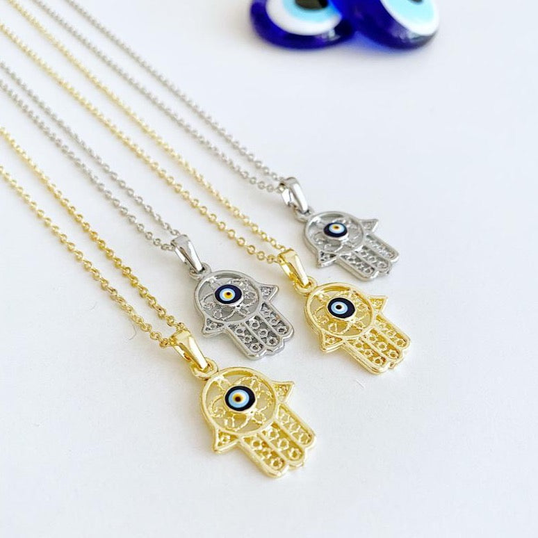 A beautiful Hamsa Evil Eye Necklace featuring a gold and silver design, showcasing a detailed Hamsa charm for protection and luck.