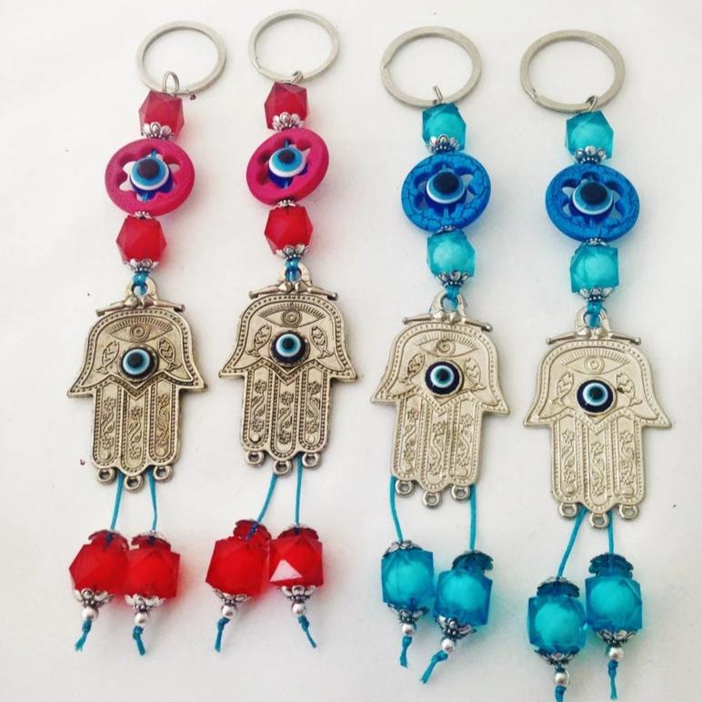 Hamsa Greek Nazar bead keychain featuring a blue and red evil eye design, symbolizing protection and good luck.