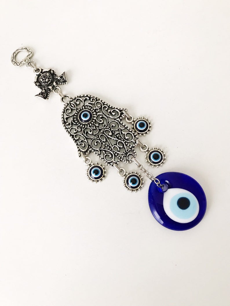 A beautifully crafted Hamsa wall art featuring an evil eye wall hanging, showcasing intricate designs and vibrant colors.