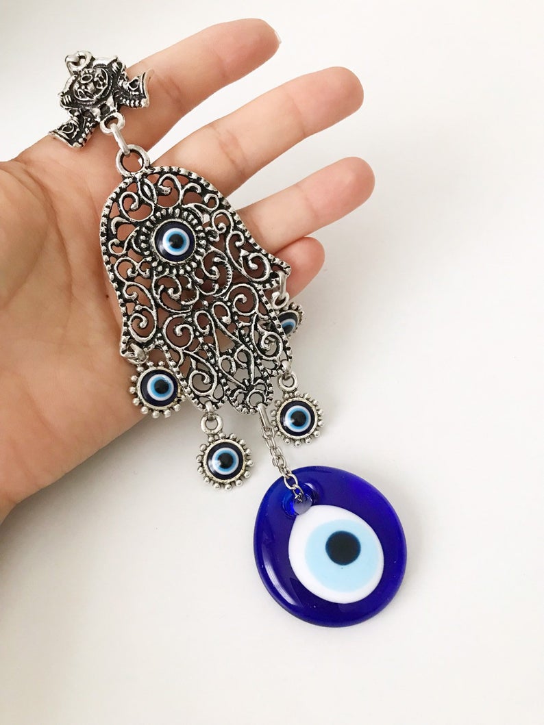 A beautifully crafted Hamsa wall art featuring an evil eye wall hanging, showcasing intricate designs and vibrant colors.