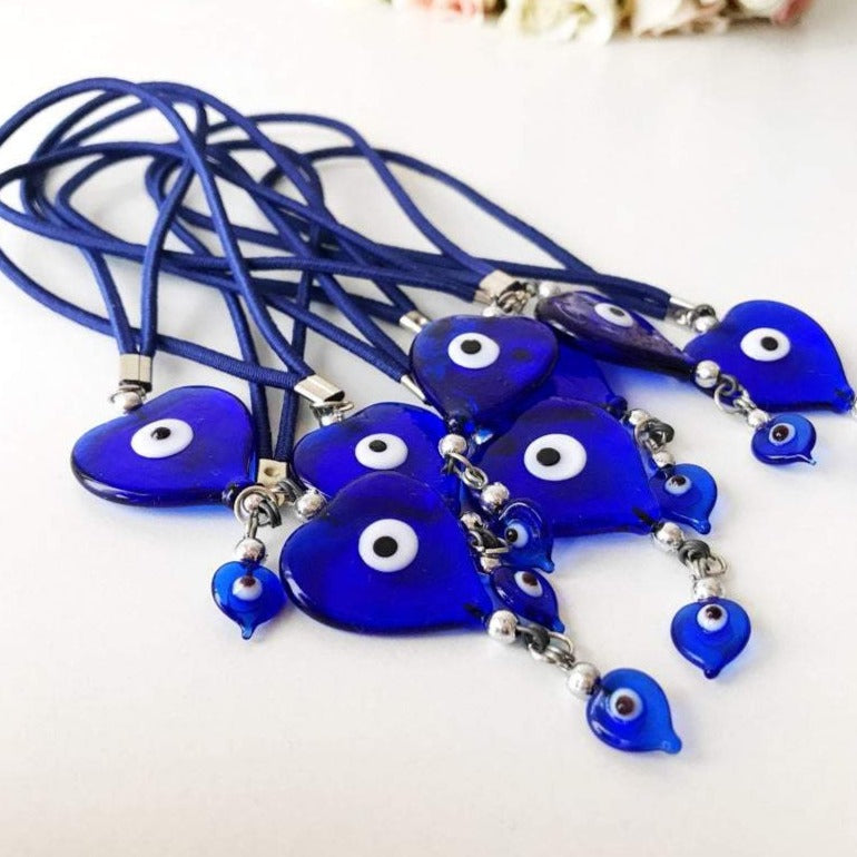 Handmade evil eye car mirror love charm featuring glass beads and heart-shaped evil eye bead, perfect for vehicle decoration.