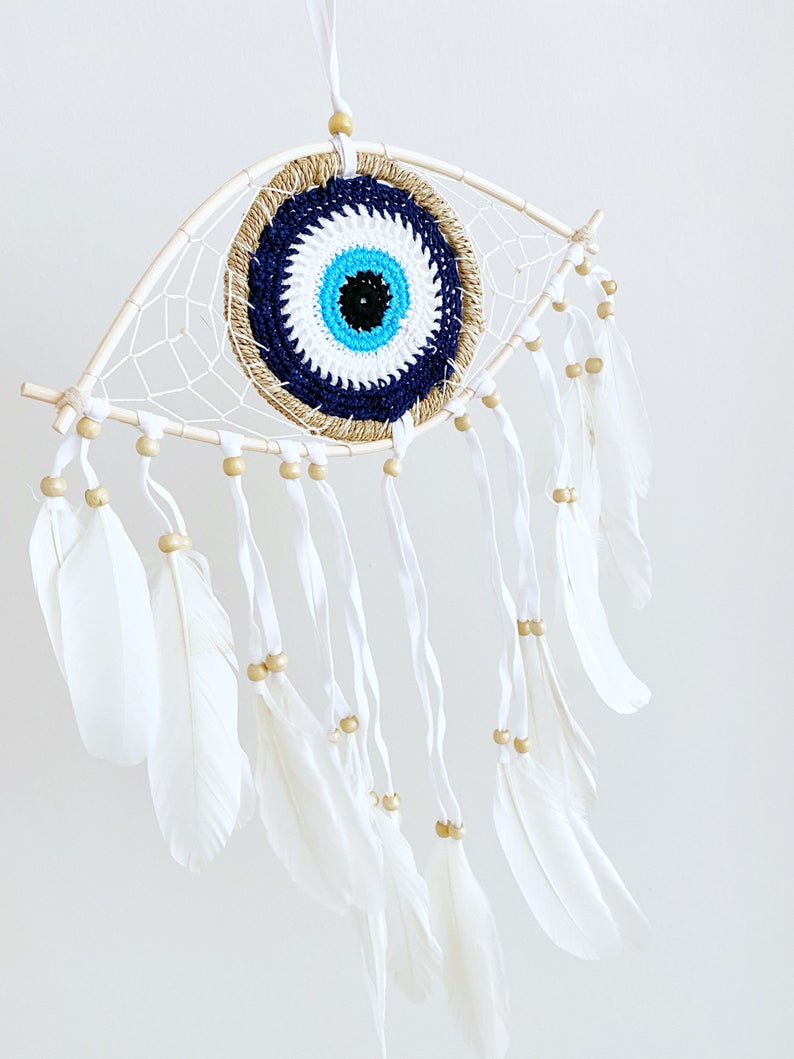 Handmade Evil Eye Dream Catcher featuring blue evil eye design, feathers, and bamboo frame, perfect for home decor and protection.
