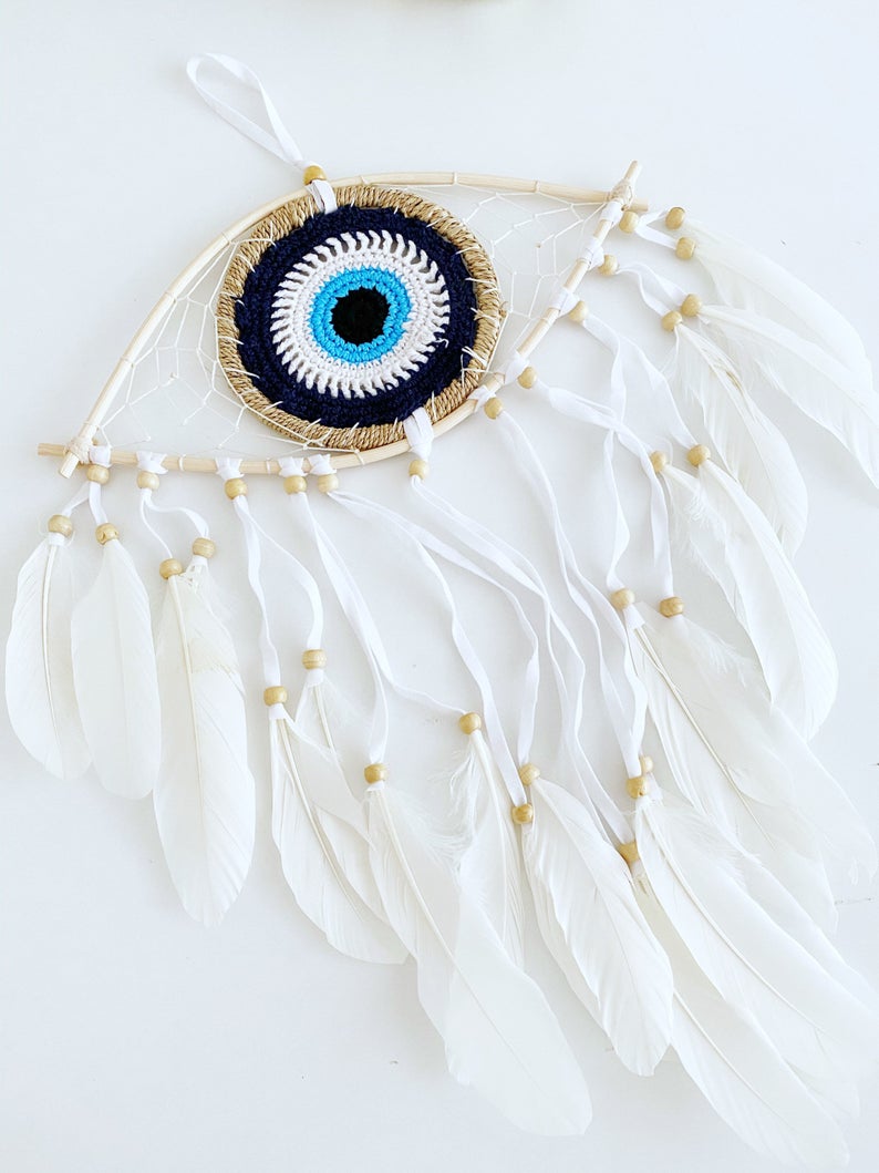 Handmade Evil Eye Dream Catcher featuring blue evil eye design, feathers, and bamboo frame, perfect for home decor and protection.