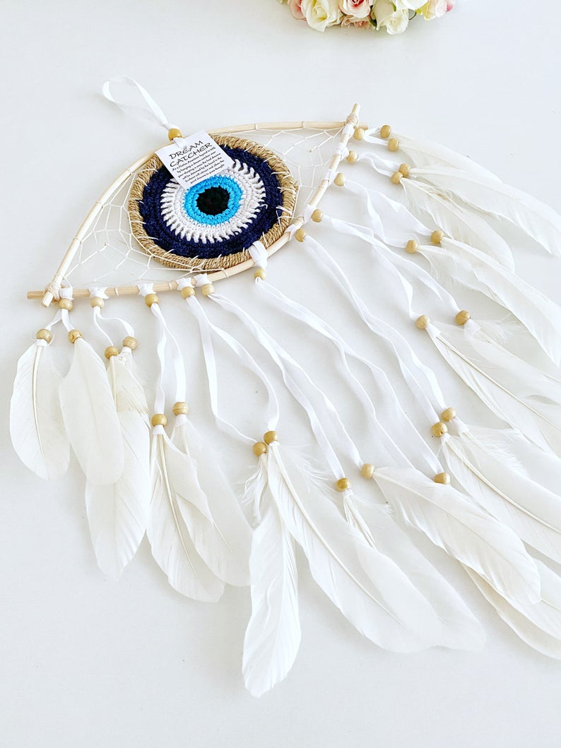 Handmade Evil Eye Dream Catcher featuring blue evil eye design, feathers, and bamboo frame, perfect for home decor and protection.