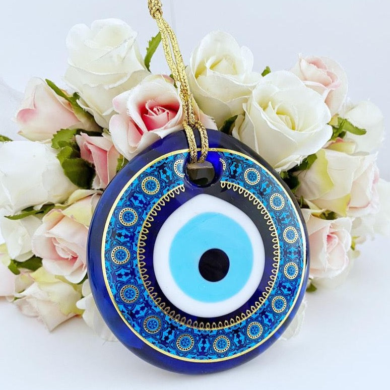 A beautifully crafted handmade glass evil eye bead, featuring intricate patterns and a vibrant blue color, symbolizing protection and good fortune.