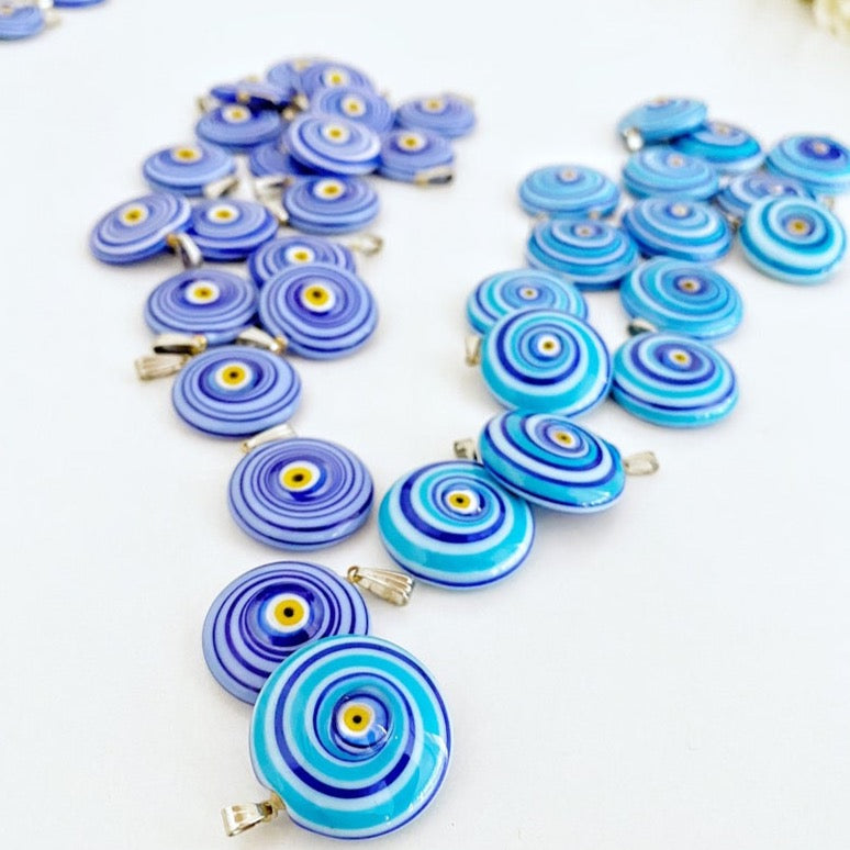 Handmade Murano bead featuring a blue evil eye charm, showcasing intricate glasswork and vibrant color.