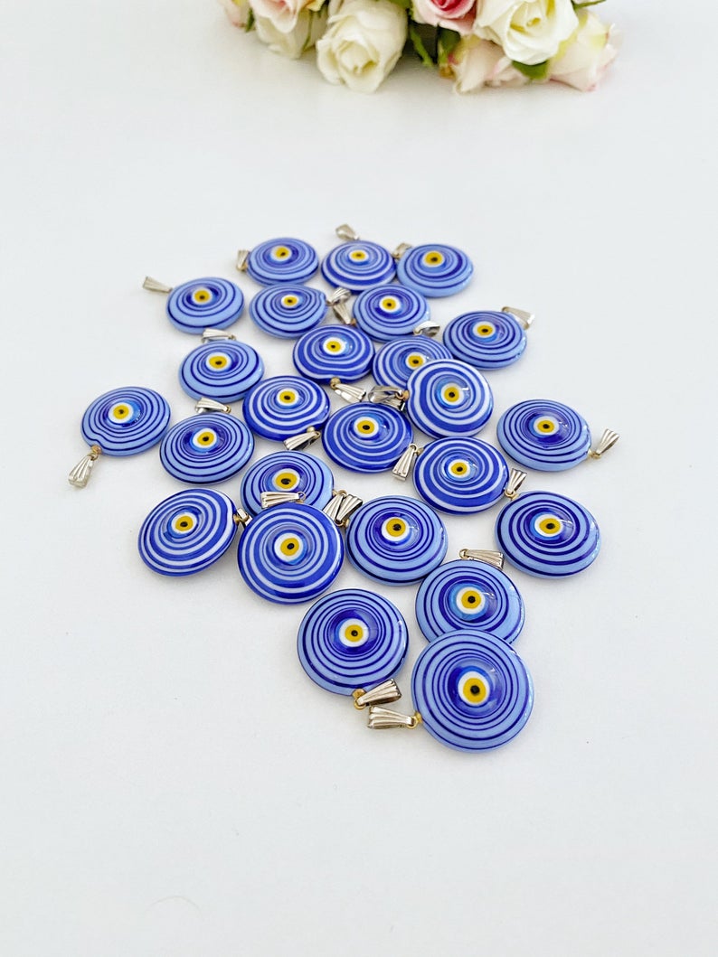 Handmade Murano bead featuring a blue evil eye charm, showcasing intricate glasswork and vibrant color.
