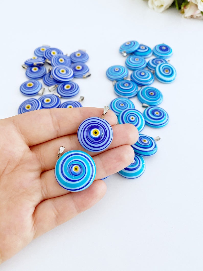 Handmade Murano bead featuring a blue evil eye charm, showcasing intricate glasswork and vibrant color.