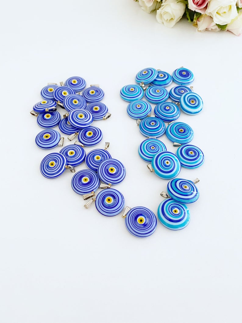 Handmade Murano bead featuring a blue evil eye charm, showcasing intricate glasswork and vibrant color.