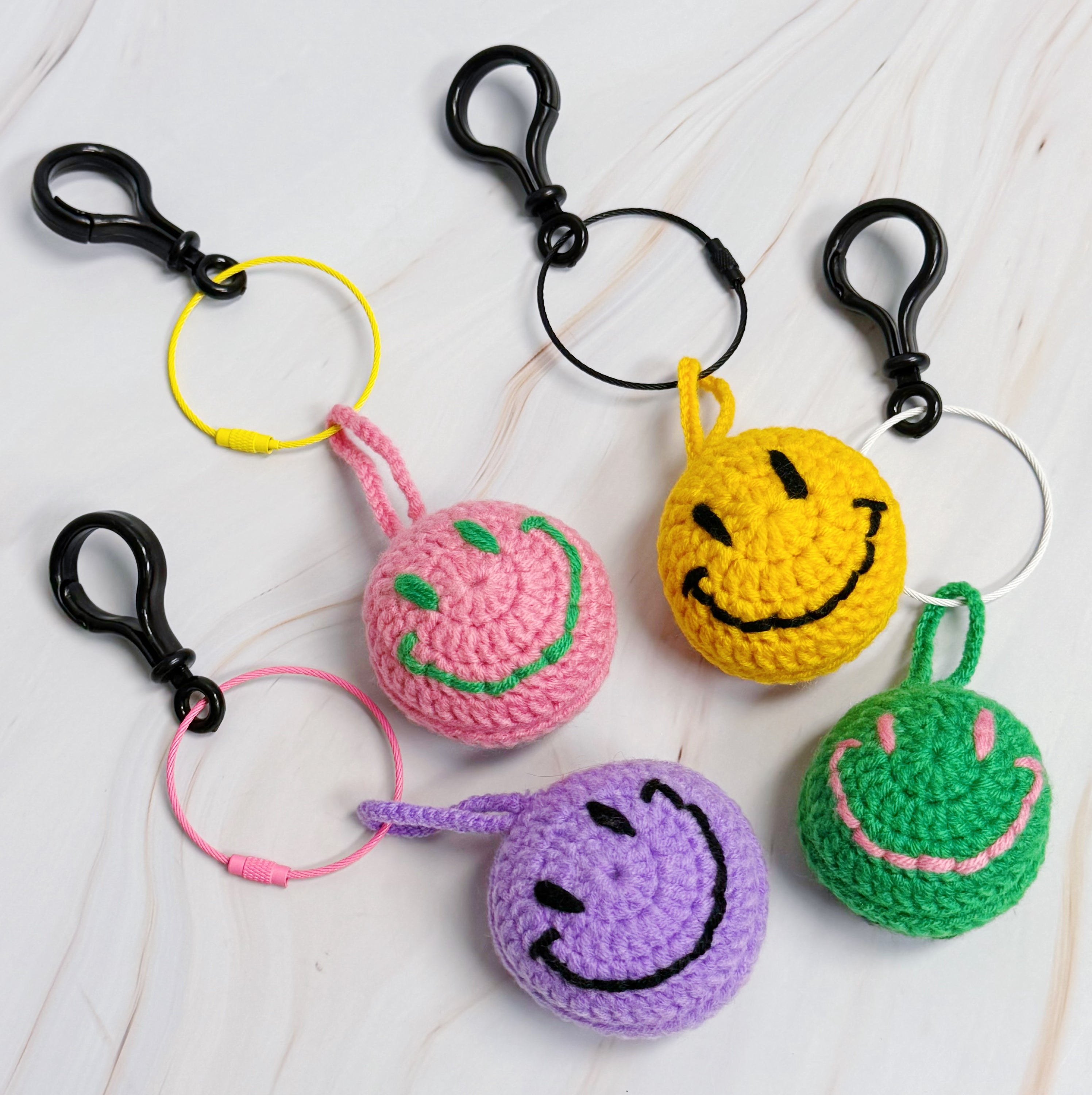 Happy Face Puffy Ball Key Ring with colorful knitted design and secure locking mechanism, perfect for keys and bags.