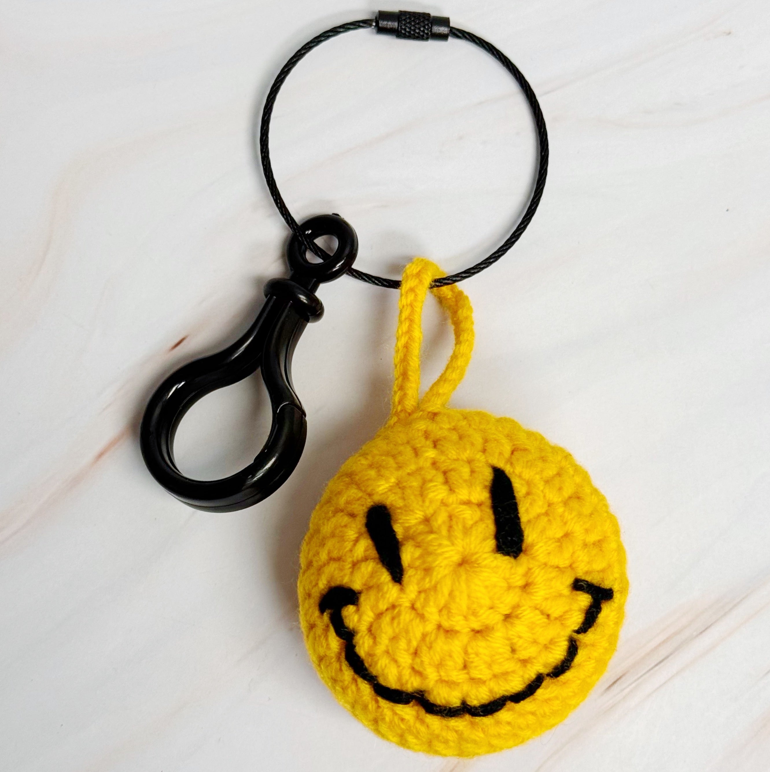 Happy Face Puffy Ball Key Ring with colorful knitted design and secure locking mechanism, perfect for keys and bags.
