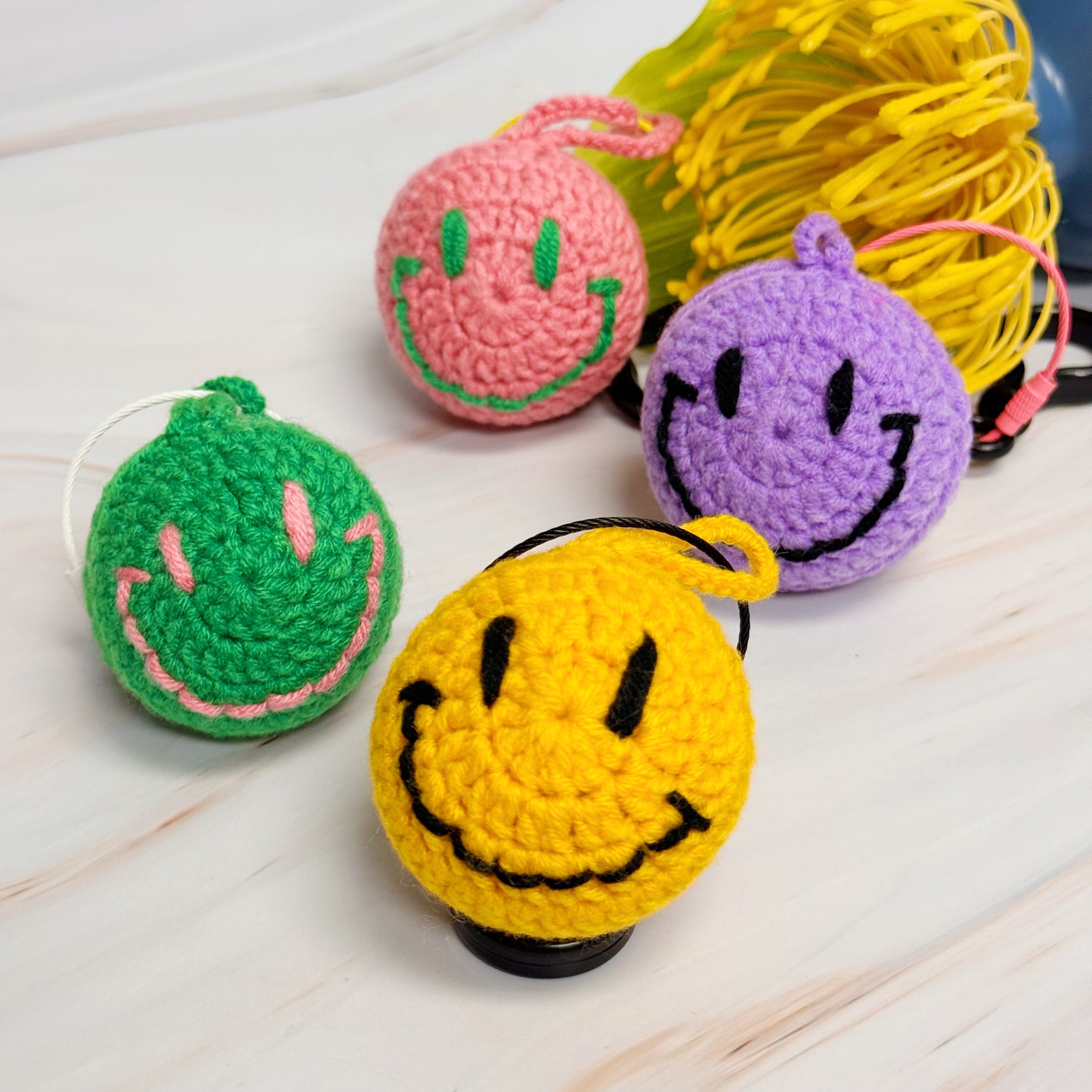 Happy Face Puffy Ball Key Ring with colorful knitted design and secure locking mechanism, perfect for keys and bags.