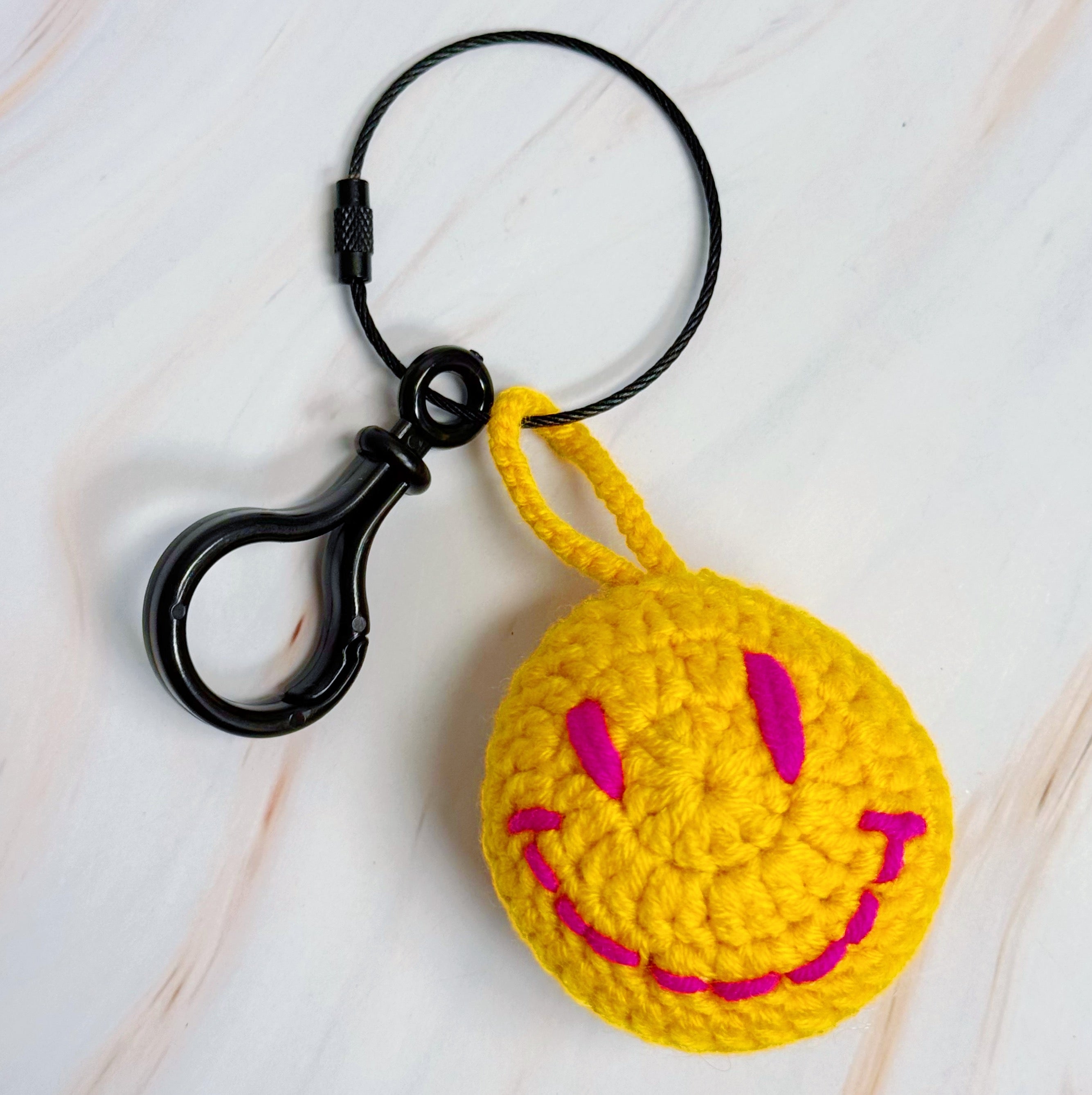 Happy Face Puffy Ball Key Ring with colorful knitted design and secure locking mechanism, perfect for keys and bags.