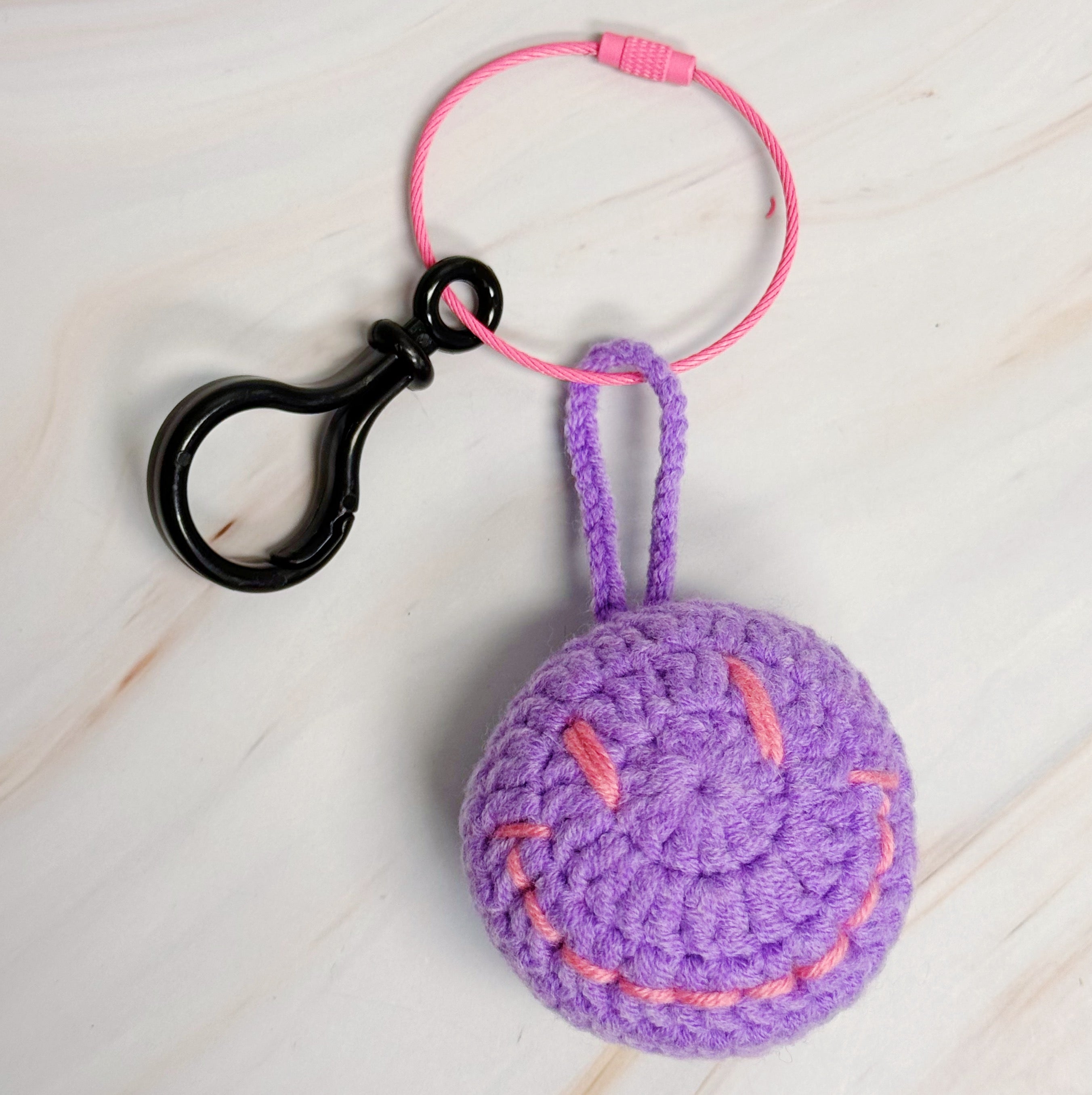 Happy Face Puffy Ball Key Ring with colorful knitted design and secure locking mechanism, perfect for keys and bags.