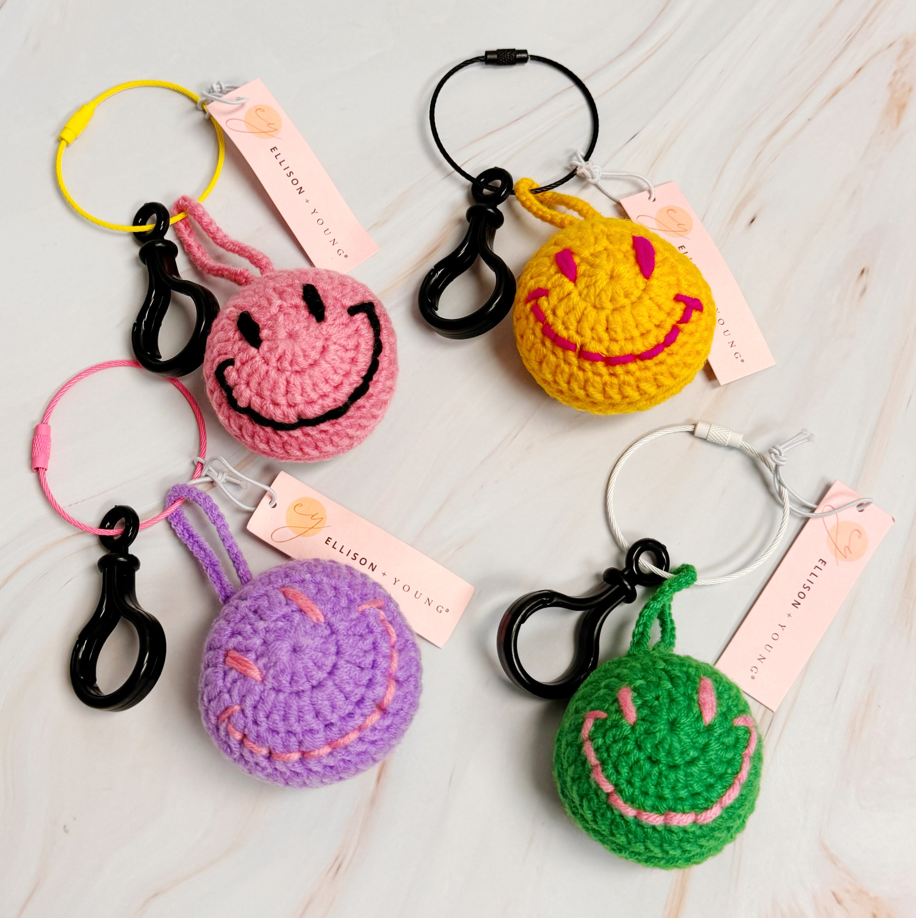 Happy Face Puffy Ball Key Ring with colorful knitted design and secure locking mechanism, perfect for keys and bags.