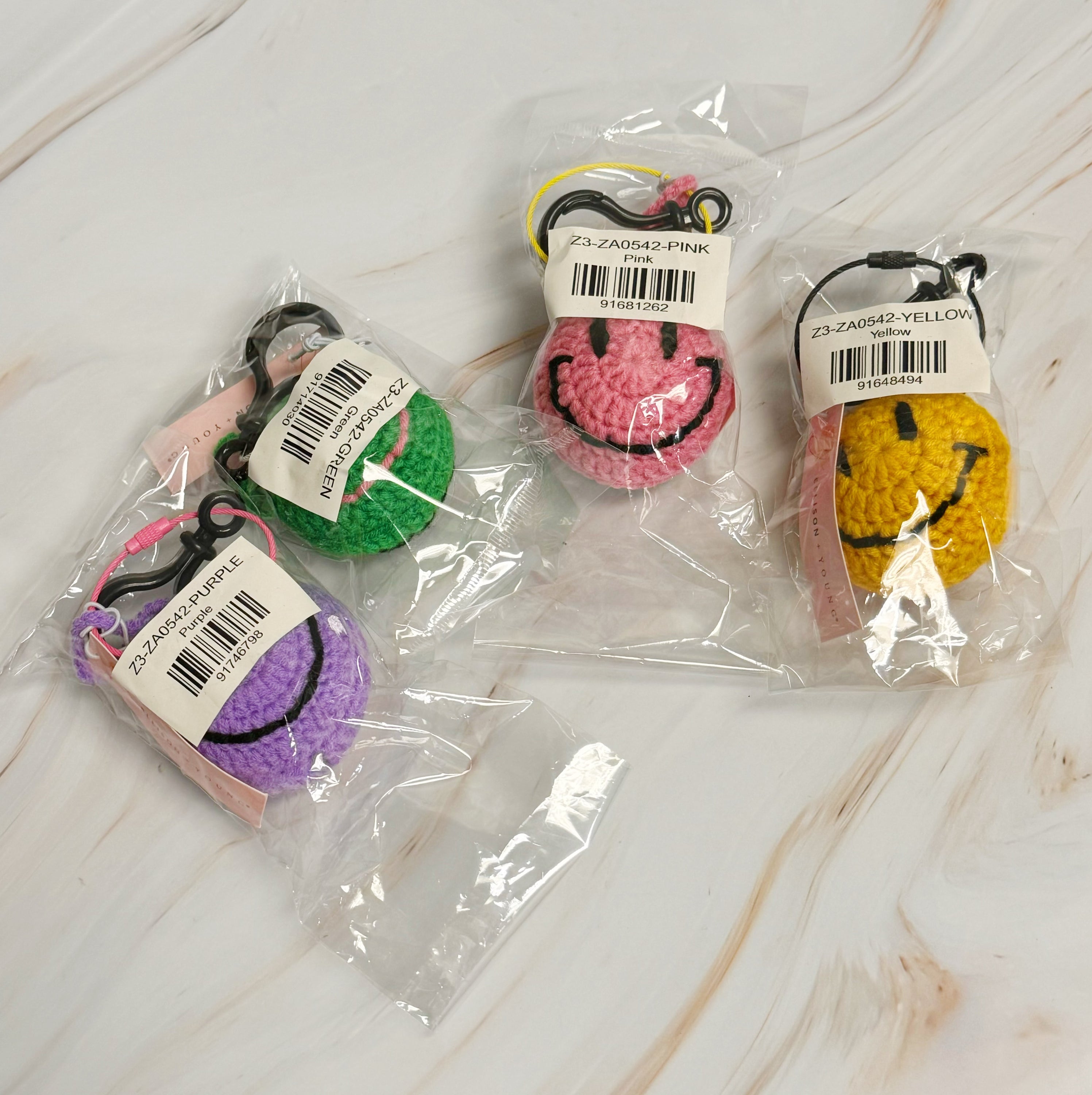Happy Face Puffy Ball Key Ring with colorful knitted design and secure locking mechanism, perfect for keys and bags.