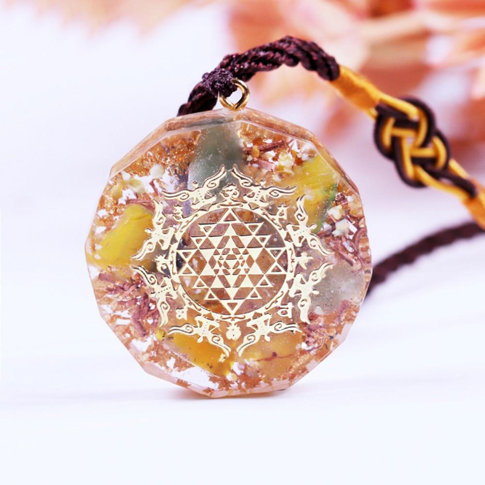Healing Stones Orgone necklace featuring geometric pendant with topaz, green aventurine, and copper elements for EMF protection.