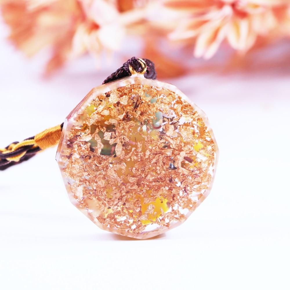 Healing Stones Orgone necklace featuring geometric pendant with topaz, green aventurine, and copper elements for EMF protection.