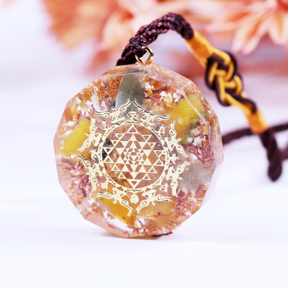Healing Stones Orgone necklace featuring geometric pendant with topaz, green aventurine, and copper elements for EMF protection.