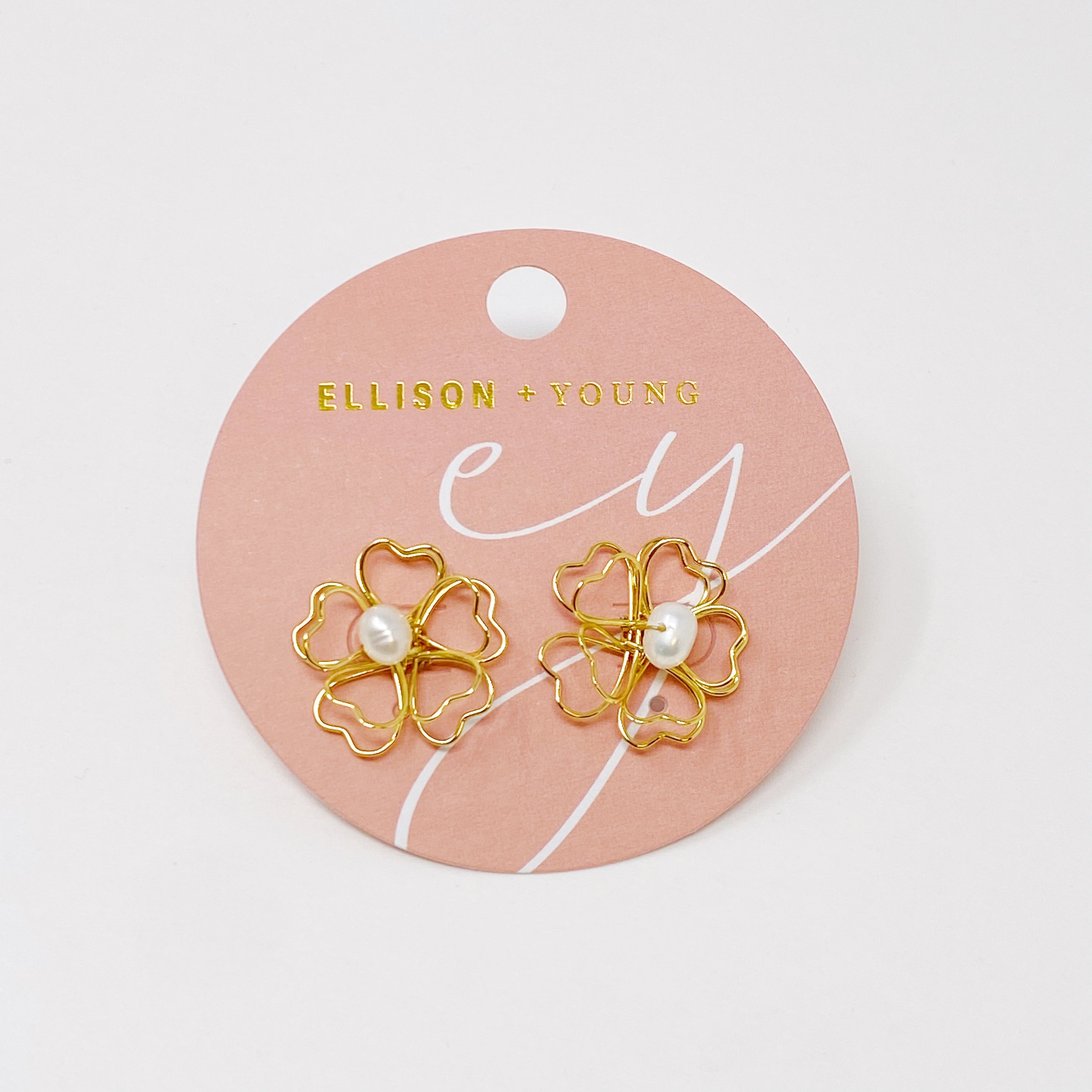 Elegant Heart Petals earrings featuring a freshwater pearl centerpiece and golden wire design.