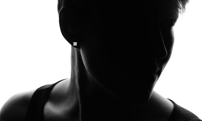 A pair of heart-shaped stud earrings made with elements in sterling silver plated, showcasing their sparkling design and secure prong setting.