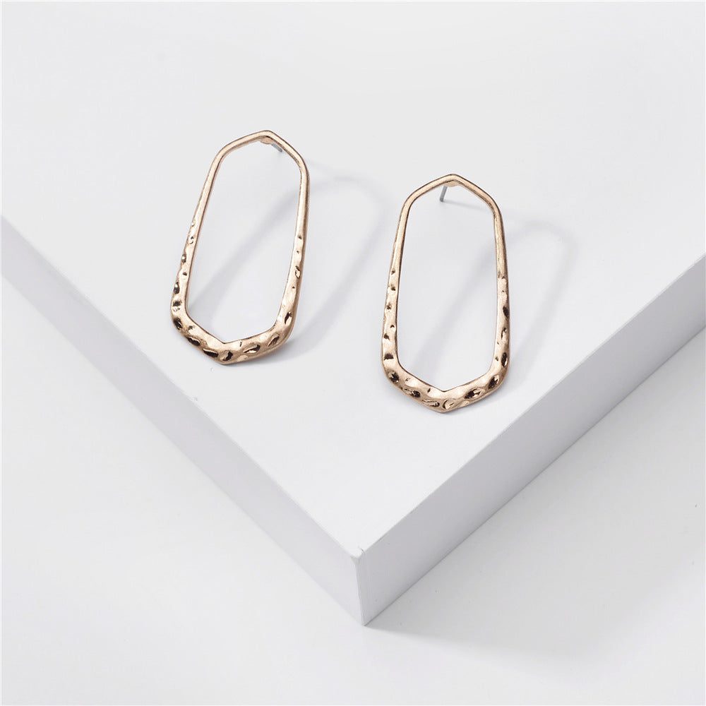 Stylish hexagon hammered metal post hoop earrings in various colors, showcasing their unique design and elegant finish.