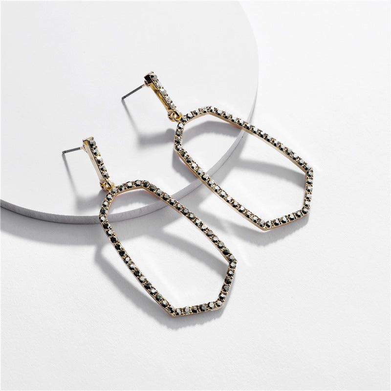 Hexagon Stone Ring Post Earrings by DOBBI in various colors, showcasing a modern geometric design with a stone accent.