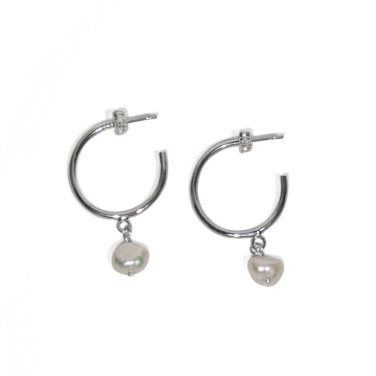 Sterling silver hoop earrings featuring a baroque freshwater pearl charm, elegantly designed for versatile wear.