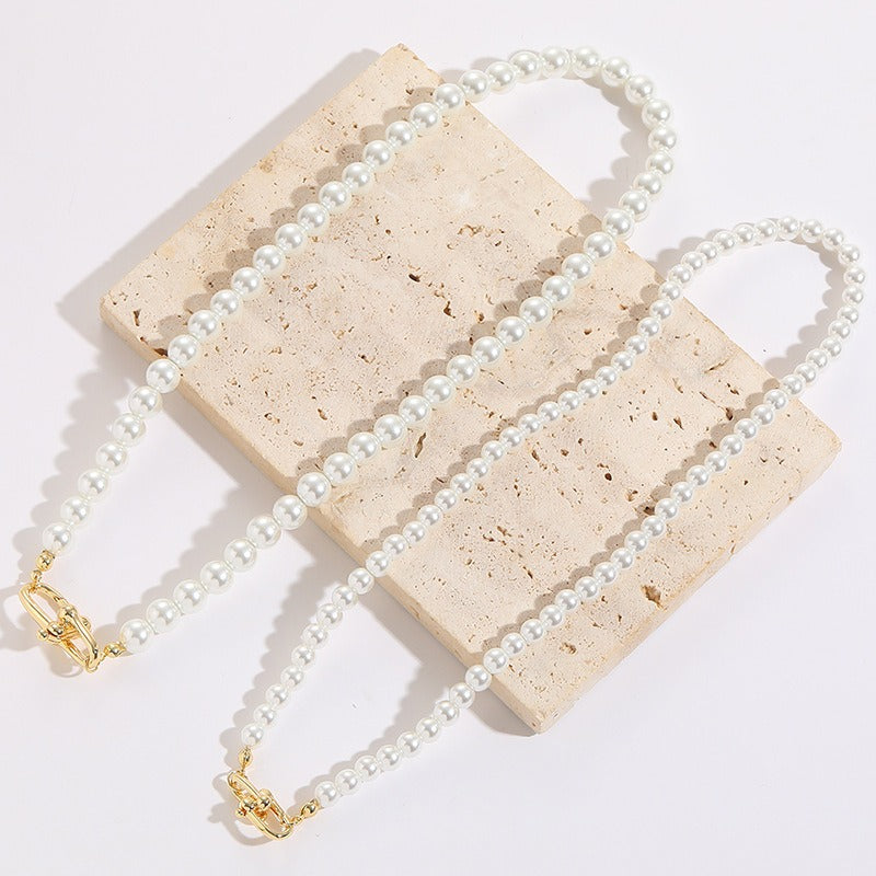 A beautiful Horseshoe Button Open Pendant Pearl Necklace featuring an imitation pearl and Mother of Pearl Shell pendant, showcasing a vintage French design.