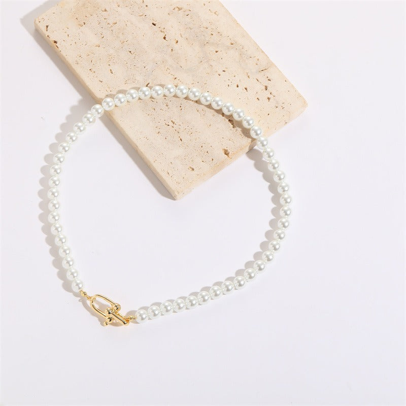 A beautiful Horseshoe Button Open Pendant Pearl Necklace featuring an imitation pearl and Mother of Pearl Shell pendant, showcasing a vintage French design.