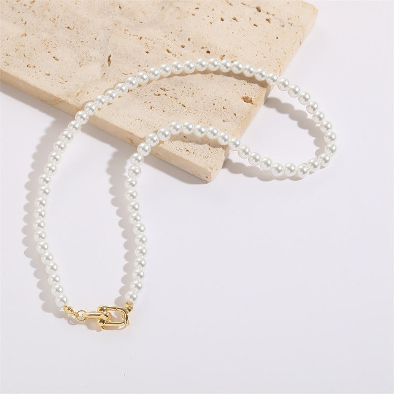 A beautiful Horseshoe Button Open Pendant Pearl Necklace featuring an imitation pearl and Mother of Pearl Shell pendant, showcasing a vintage French design.