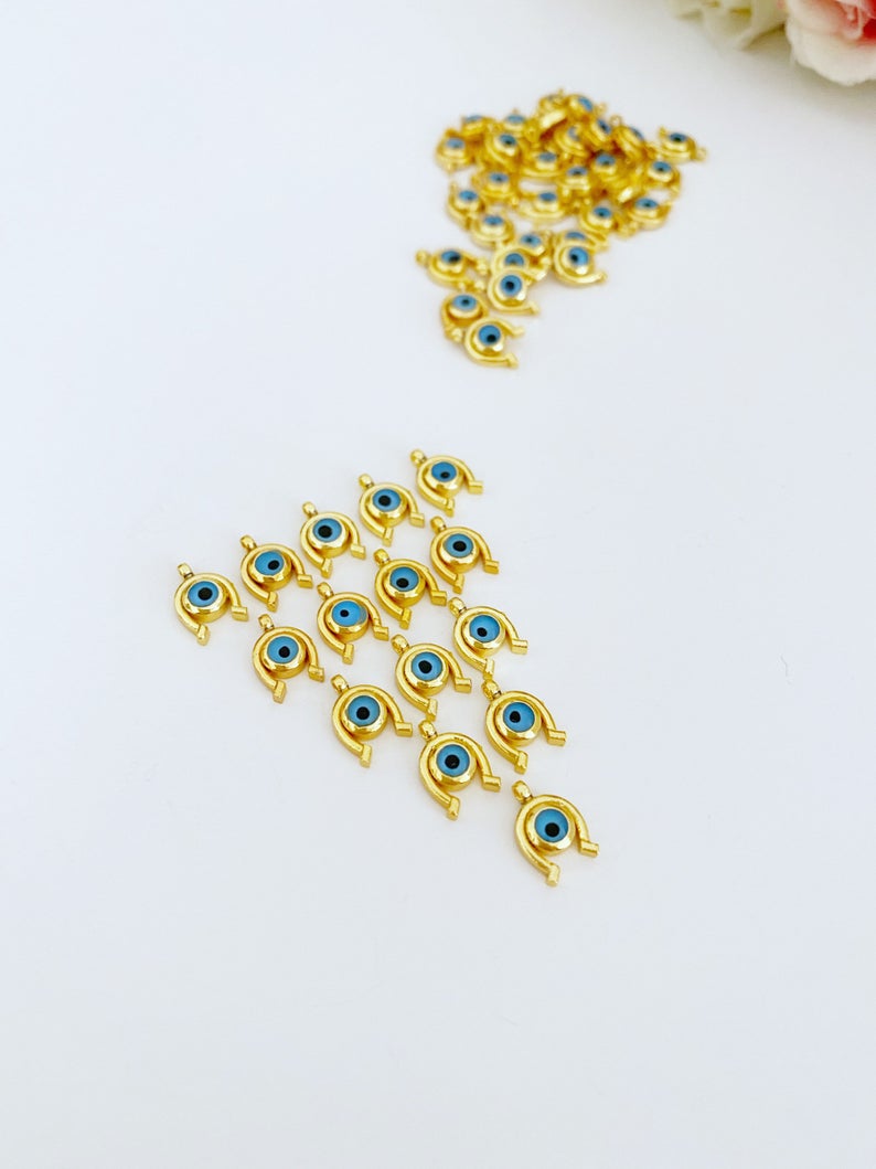 Five mini gold horseshoe evil eye charms, 24K gold plated, perfect for jewelry making.