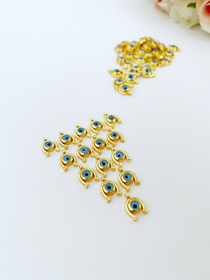 Five mini gold horseshoe evil eye charms, 24K gold plated, perfect for jewelry making.