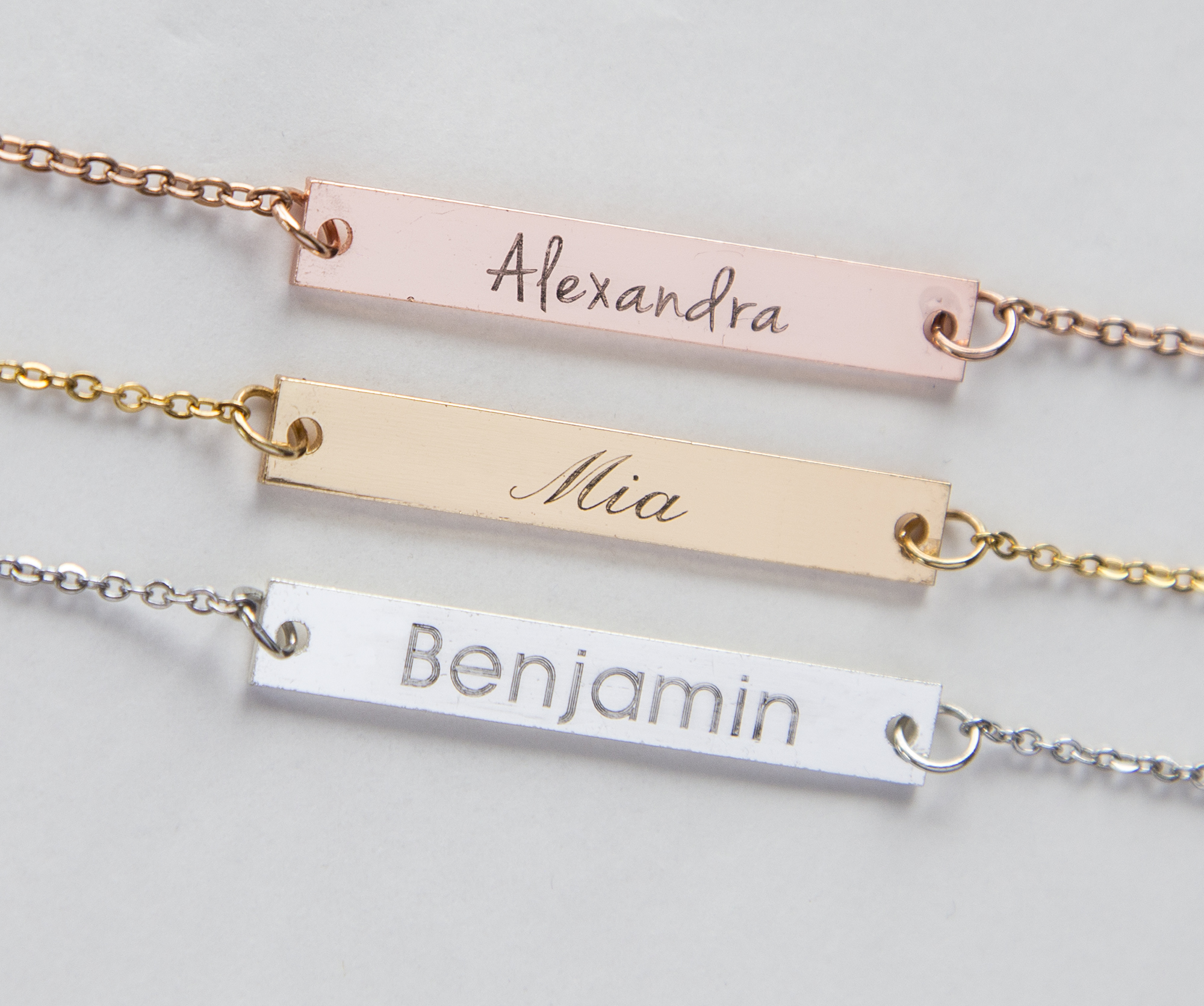 Hand-stamped golden bar necklace with the phrase 'I Am Enough', showcasing its unique design and craftsmanship.