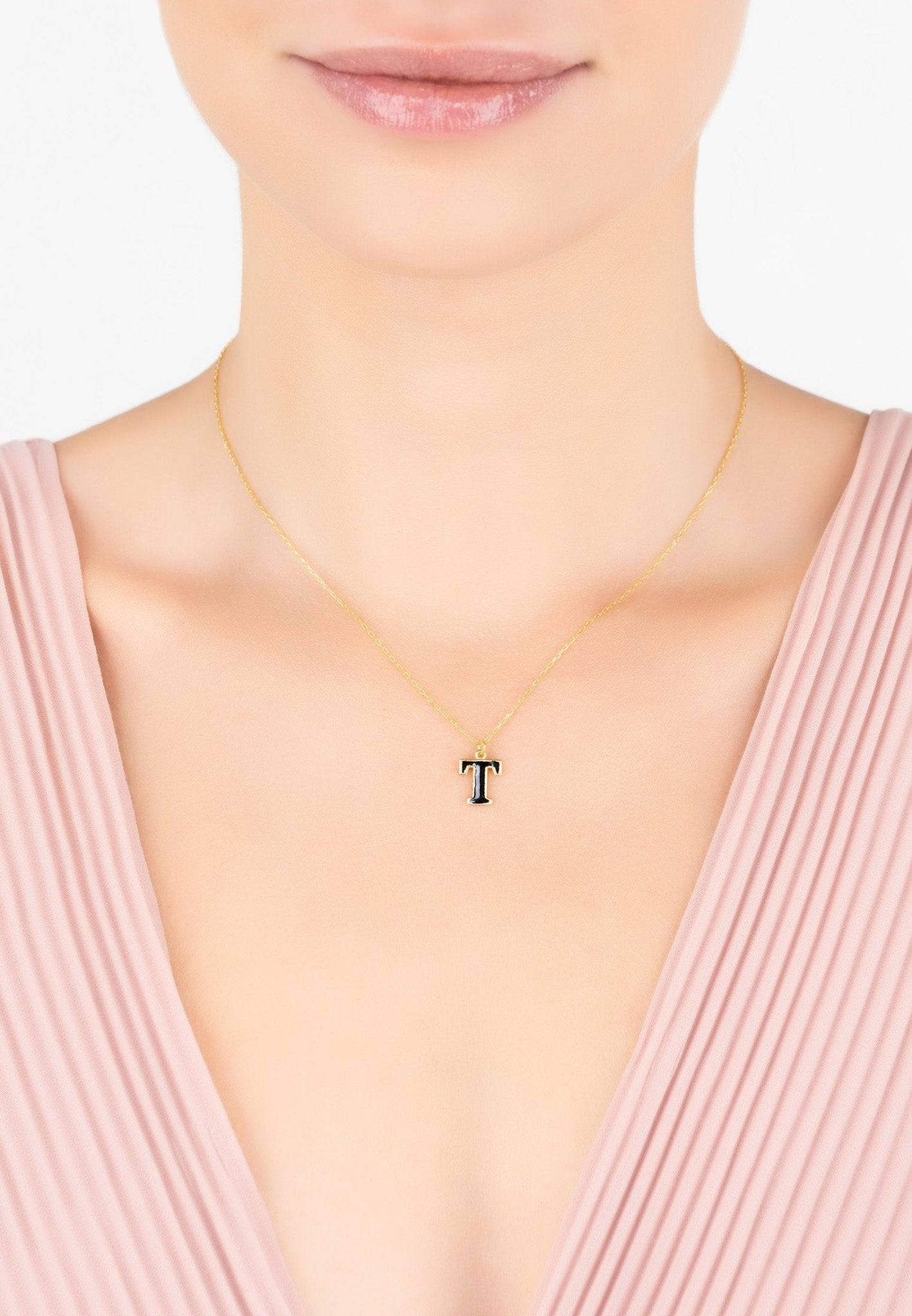 Elegant Initial Enamel Necklace Gold T featuring a black enamel pendant on a gold chain, perfect for personal styling.