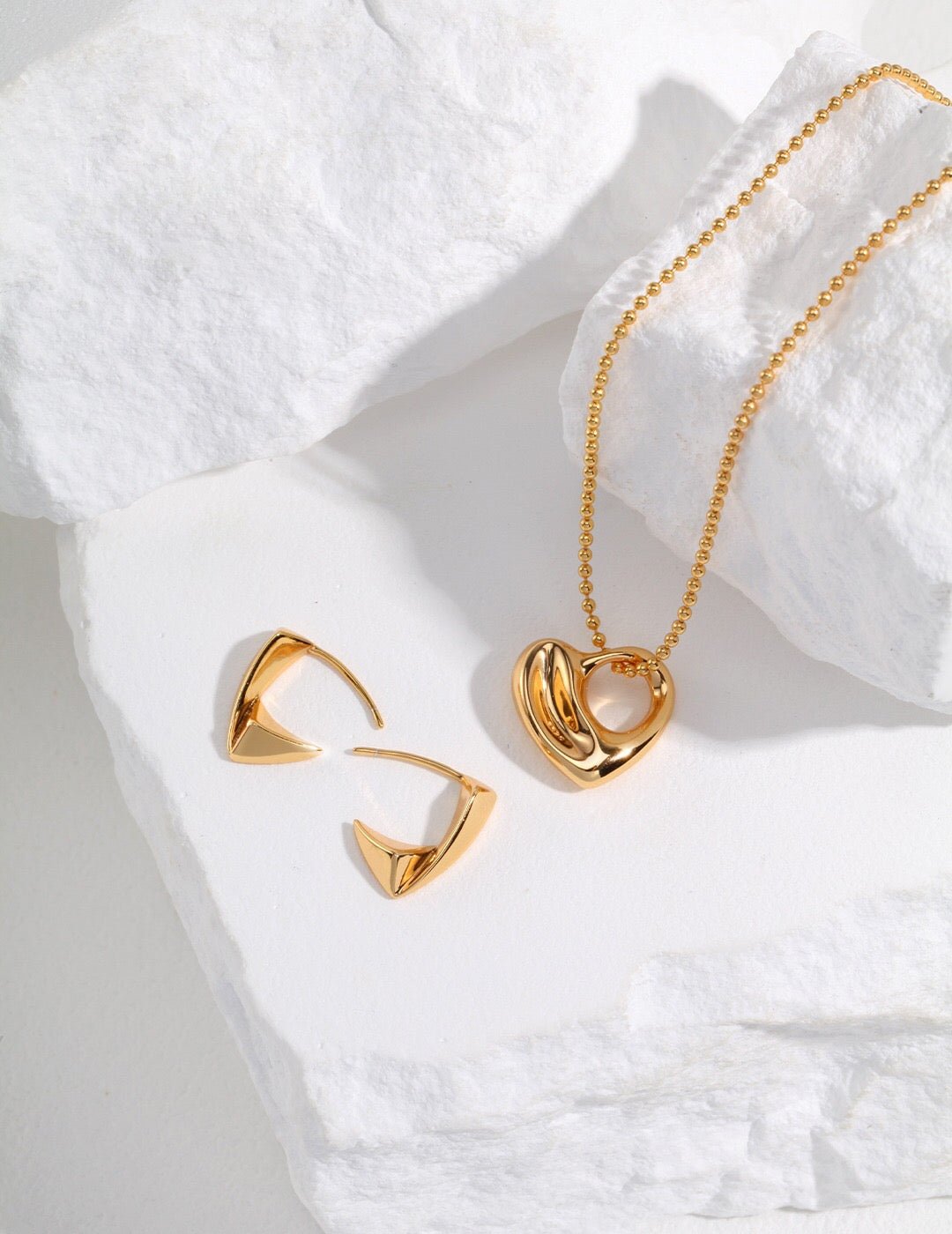A stunning Irregular Hollow Heart Necklace made of gold vermeil, featuring a unique design and adjustable chain.