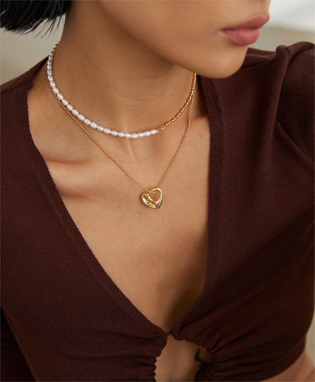 A stunning Irregular Hollow Heart Necklace made of gold vermeil, featuring a unique design and adjustable chain.