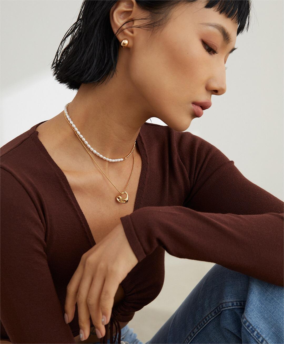 A stunning Irregular Hollow Heart Necklace made of gold vermeil, featuring a unique design and adjustable chain.