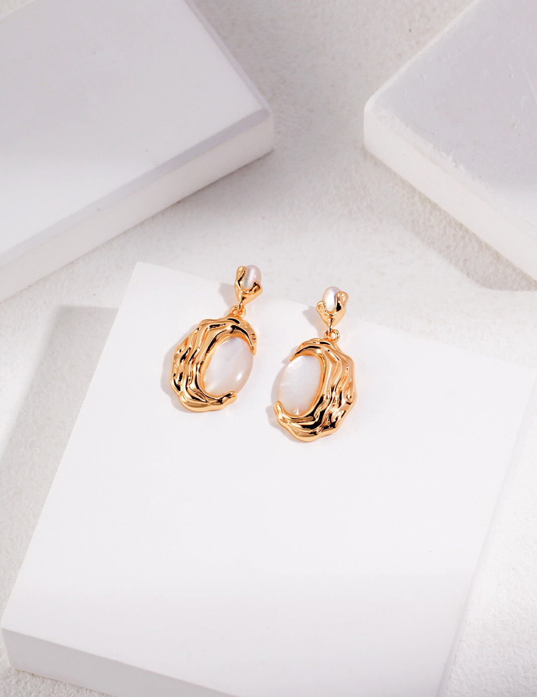 A pair of Irregular Lava Style Natural Mother-of-Pearl Earrings featuring a unique design, handcrafted with sterling silver and gold vermeil.