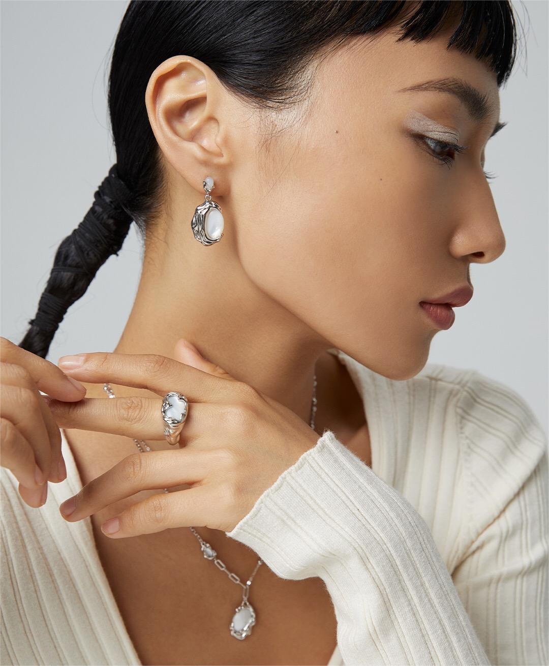 A pair of Irregular Lava Style Natural Mother-of-Pearl Earrings featuring a unique design, handcrafted with sterling silver and gold vermeil.