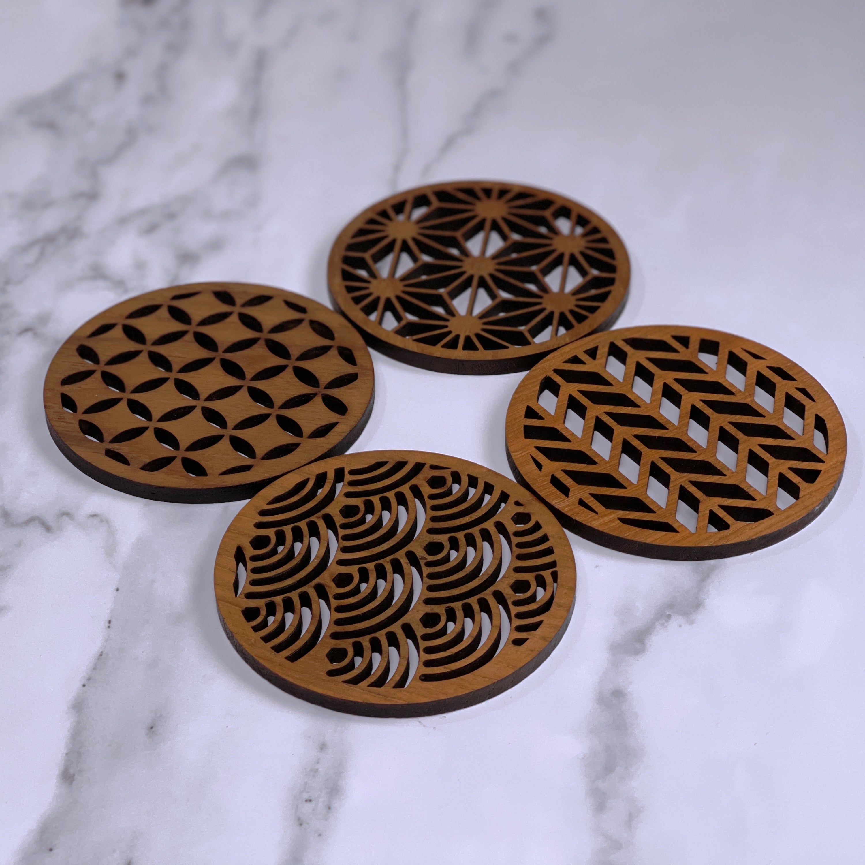 Set of four Japanese patterns upcycled teak wood coasters, showcasing unique designs and eco-friendly craftsmanship.