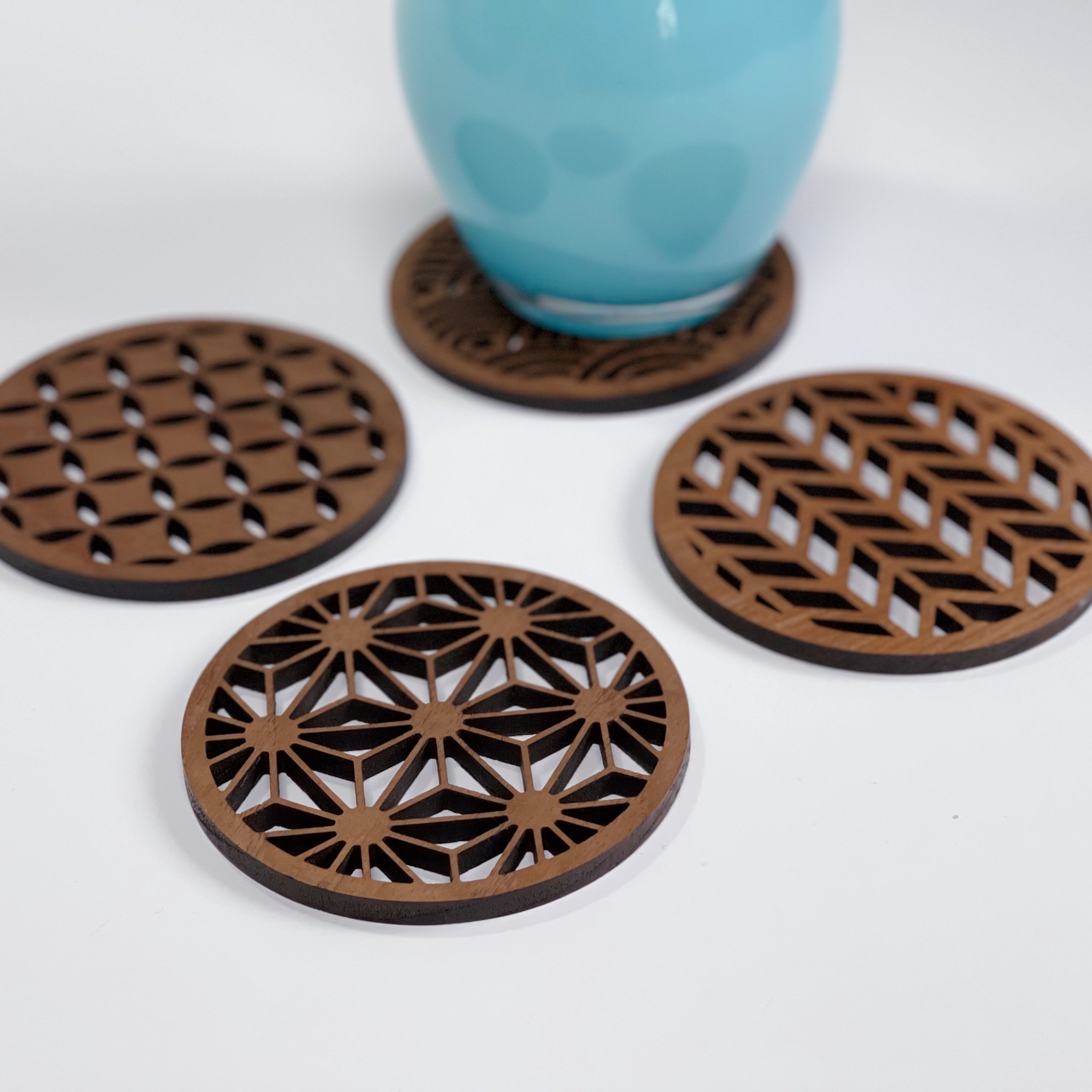 Set of four Japanese patterns upcycled teak wood coasters, showcasing unique designs and eco-friendly craftsmanship.